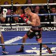 Britain's Terry Flanagan (L) measures Puerto Rico's Orlando Cruz (L) during their World Boxing Organisation lightweight title bout held at the Motorpoint Arena, November 26, 2016