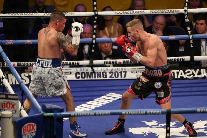 Britain's Terry Flanagan (L) measures Puerto Rico's Orlando Cruz (L) during their World Boxing Organisation lightweight title bout held at the Motorpoint Arena, November 26, 2016