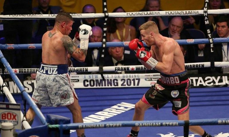Britain's Terry Flanagan (L) measures Puerto Rico's Orlando Cruz (L) during their World Boxing Organisation lightweight title bout held at the Motorpoint Arena, November 26, 2016