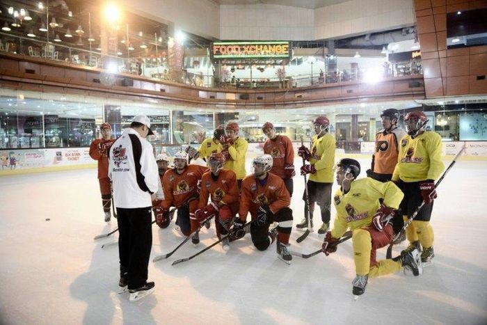 Indonesian ice hockey team players listen to their Malaysian coach Gary Tan (L in white) at a skating rink in South Tangerang, ahead of the Asian Winter Games in Sapporo