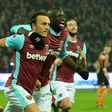 West Ham United's English midfielder Mark Noble (L) celebrates after scoring the opening goal from the penalty spot during a match against Hull City at The London Stadium on December 17, 2016