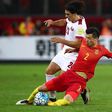 China's Mei Fang (right) competes for the ball with Qatar's Sebastian Soria during their 2018 World Cup qualifier in Kunming on November 15, 2016
