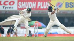Indian batsman Cheteshwar Pujara plays a shot as Australian wicketkeeper Matthew Wade looks on on the fourth day of their third Test match, at The Jharkhand State Cricket Association (JSCA) Stadium Complex in Ranchi, on March 19, 2017