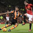 Hull City's Tom Huddlestone (L) clears the ball from the path of Manchester United's Juan Mata during their League Cup semi-final first leg match, at Old Trafford in Manchester, on January 10, 2017
