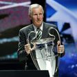 Billy McNeill holds the Champions League trophy during the 2013/14 group stage draw in Monaco