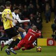 Tottenham's English midfielder Dele Alli (C) scores his team's third goal past Watford's Brazilian goalkeeper Heurelho Gomes during the Premier League match at Vicarage Road Stadium in Watford, north of London on January 1, 2017