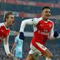 Arsenal striker Alexis Sanchez (R) celebrates with teammate Nacho Monreal after scoring a late winner from the penalty spot during the English Premier League match against Burnley at the Emirates Stadium in London on January 22, 2017