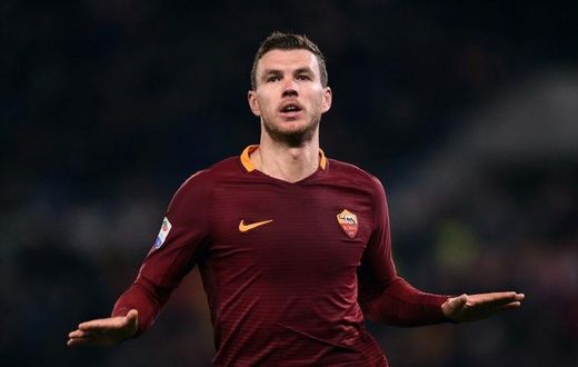Roma's forward from Bosnia-Herzegovina Edin Dzeko celebrates after scoring during the Italian Serie A football match Roma vs Fiorentina at the Olympic Stadium in Rome on February 7, 2017