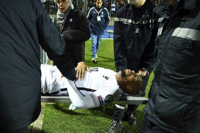 France's defender Djibril Sidibe is stretched away from the pitch following an injury during the FIFA World Cup 2018 qualifying football match Luxembourg vs France on March 25, 2017 at Josy Bartel stadium in Luxembourg