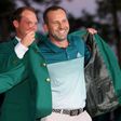 Danny Willett of England presents Sergio Garcia of Spain with the green jacket after Garcia won in a playoff during the final round of the 2017 Masters tournament, at Augusta National Golf Club in Georgia, on April 9