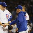 Manager Joe Maddon of the Chicago Cubs relieves Kyle Hendricks in the sixth inning against the Los Angeles Dodgers, during game two of the National League Championship Series, at Wrigley Field in Chicago, Illinois, on October 16, 2016