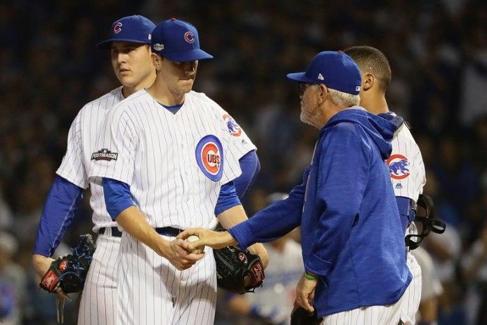 Manager Joe Maddon of the Chicago Cubs relieves Kyle Hendricks in the sixth inning against the Los Angeles Dodgers, during game two of the National League Championship Series, at Wrigley Field in Chicago, Illinois, on October 16, 2016