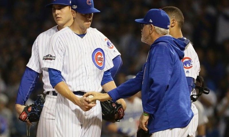 Manager Joe Maddon of the Chicago Cubs relieves Kyle Hendricks in the sixth inning against the Los Angeles Dodgers, during game two of the National League Championship Series, at Wrigley Field in Chicago, Illinois, on October 16, 2016