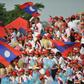 Laos supporters wave national flags during a football match in Vientiane
