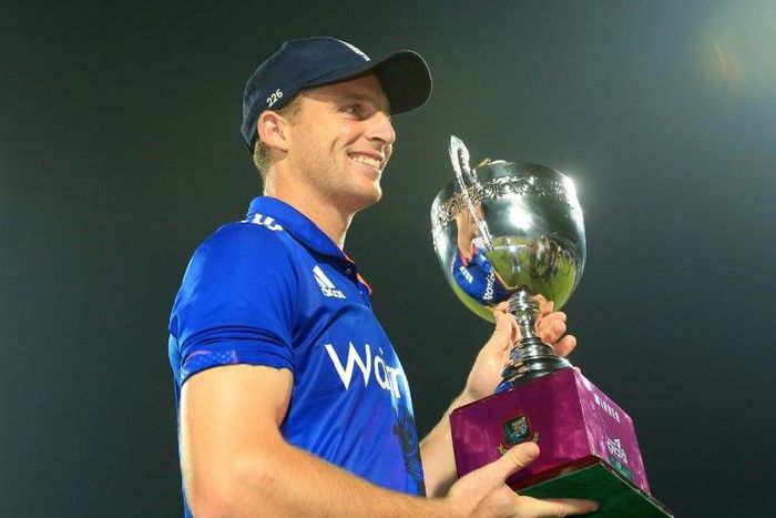 England captain Jos Buttler poses with the series trophy after his side's victory in the third ODI against Bangladesh at The Zahur Ahmed Chowdhury Stadium in Chittagong on October 12, 2016
