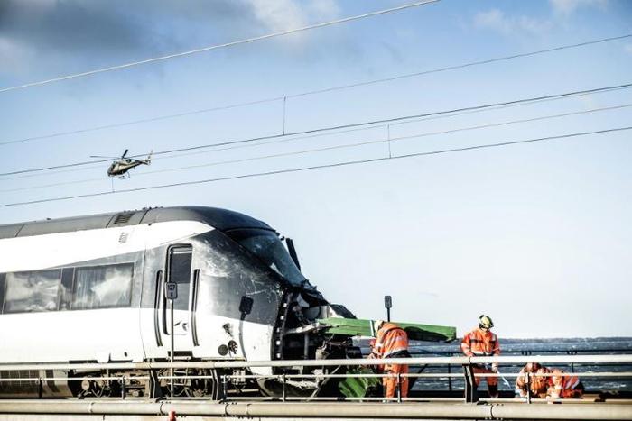 Investigators said the passenger train appeared to have struck an empty truck trailer that had blown off a cargo train