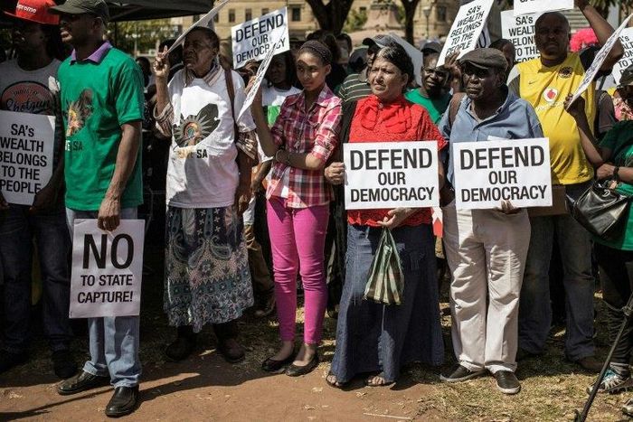 People rally outside the South African National Treasury on April 3, 2017, in Pretoria