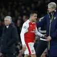 Arsenal manager Arsene Wenger (R) pats Chilean striker Alexis Sanchez on the back as he is substituted during the Champions League last 16 second leg clash with Bayern Munich at The Emirates Stadium in London on March 7, 2017