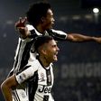 Juventus' forward Paulo Dybala (down) celebrates with Juan Cuadrado after scoring against Udinese on October 15, 2016