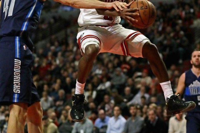 Dirk Nowitzki (L) of the Dallas Mavericks knocks the ball away from Rajon Rondo of the Chicago Bulls, at the United Center in Chicago, Illinois, on January 17, 2017
