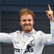 Mercedes AMG Petronas F1 Team's German driver Nico Rosberg stands on his car celebrating after winning the Formula One Japanese Grand Prix race in Suzuka on October 9, 2016