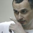 Ukrainian film director Oleg Sentsov looks out from a defendants' cage as he listens to the verdict at a military court in the southern city of Rostov-on-Don on August 25, 2015