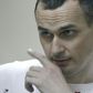 Ukrainian film director Oleg Sentsov looks out from a defendants' cage as he listens to the verdict at a military court in the southern city of Rostov-on-Don on August 25, 2015