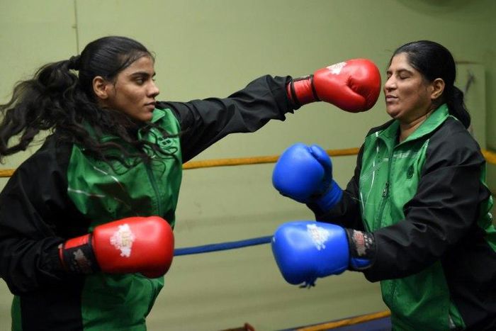 19-year-old Pakistani boxer Razia Banu (L) throws a punch at her mother Haleema Abdul Aziz during a practice session at the Pak Shaheen Boxing Club in Karachi