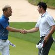 Soren Kjeldsen (L) of Denmark shakes hands with Rory McIlroy of Northern Ireland after round one of the World Golf Championships Match Play, at the Austin Country Club in Texas, on March 22, 2017