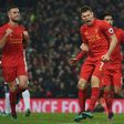 Liverpool's midfielder James Milner (C) celebrates after scoring their second goal from the penalty spot with midfielder Jordan Henderson (L) and midfielder Emre Can (R) during the Premier League football match against Sunderland November 26, 2016