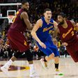 Kyrie Irving (R) of the Cleveland Cavaliers drives around Klay Thompson of the Golden State Warriors during the second half, at Quicken Loans Arena in Cleveland, Ohio, on December 25, 2016