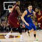 Kyrie Irving (R) of the Cleveland Cavaliers drives around Klay Thompson of the Golden State Warriors during the second half, at Quicken Loans Arena in Cleveland, Ohio, on December 25, 2016