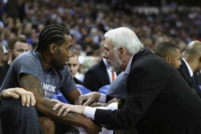 Head coach Gregg Popovich of the San Antonio Spurs talks to Kawhi Leonard during a NBA game in Sacramento, California