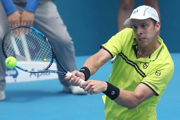 Gilles Muller of Luxembourg hits a return to Pablo Cuevas of Uruguay in their men's quarter-final match at the Sydney International tennis tournament, on January 12, 2017