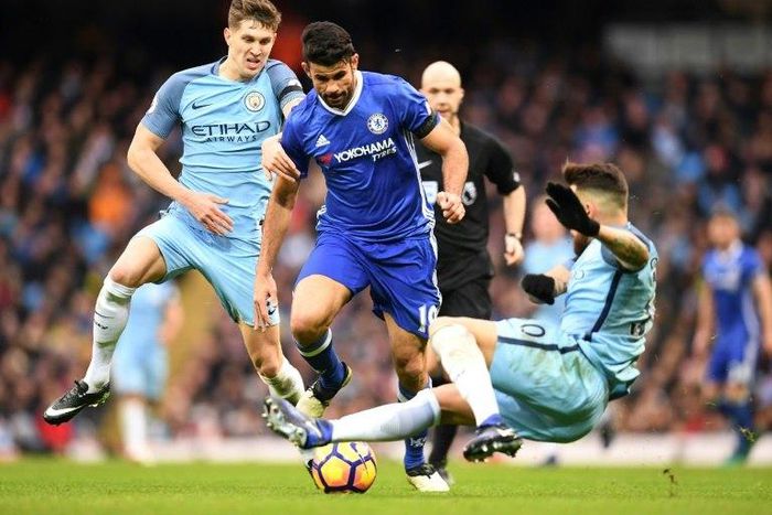 Chelsea's striker Diego Costa (C) vies with Manchester City's defender John Stones (L) and defender Nicolas Otamendi during the English Premier League football match December 3, 2016