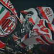 AC Milan supporters wave flags during a serie A match against Juventus