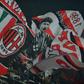 AC Milan supporters wave flags during a serie A match against Juventus