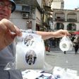 A vendor shows toilet paper rolls with portraits of Juventus' Argentinian forward Gonzalo Higuain on March 23, 2017 in a street of Naples