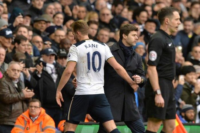 Tottenham Hotspur's Harry Kane (L) is greeted by team manager Mauricio Pochettino as he leaves the pitch substituted during their English Premier League match against Stoke City, at White Hart Lane in London, on February 26, 2017