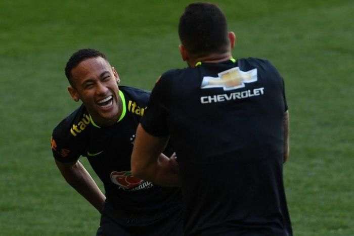 Brazil's footballer Neymar (L) jokes with teammate Renato Augusto during a training session at Mineirao stadium in Belo Horizonte, Minas Gerais, Brazil, on November 8, 2016