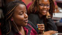 Female African student speaking in a classroom