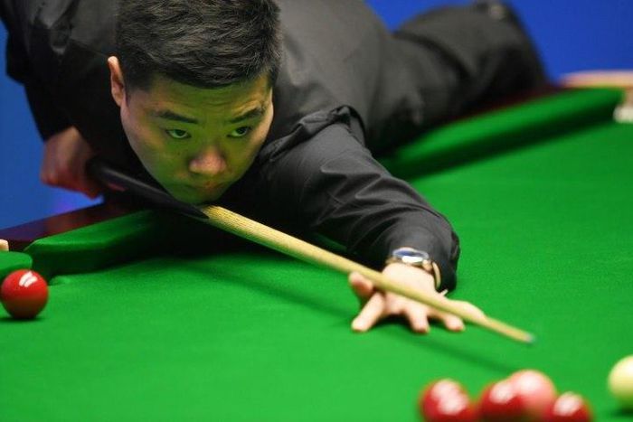 China's Ding Junhui plays a shot against China's Zhou Yuelong during their first round game of the World Snooker Championships in Sheffield, northern England, on April 18, 2017