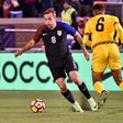 Jordan Morris (L) of the US fights for the ball with Sergio Campbell of Jamaica during the first half of their friendly match, at Finley Stadium in Chattanooga, Tennessee, on February 3, 2017