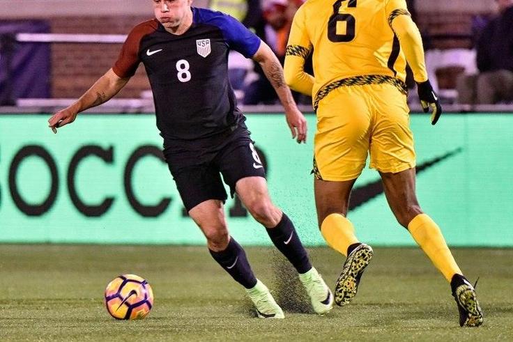 Jordan Morris (L) of the US fights for the ball with Sergio Campbell of Jamaica during the first half of their friendly match, at Finley Stadium in Chattanooga, Tennessee, on February 3, 2017
