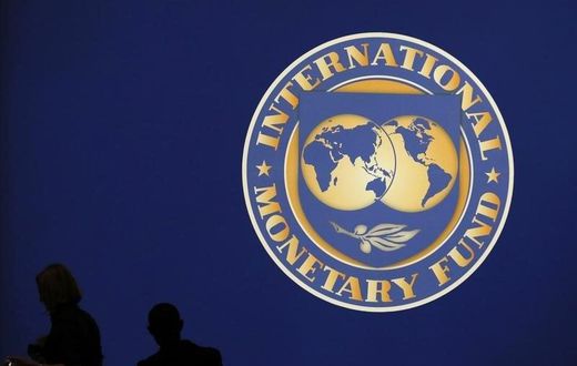 Visitors are silhouetted against the logo of the International Monetary Fund at the main venue for the IMF and World Bank annual meeting in Tokyo October 10, 2012.     REUTERS/Kim Kyung-Hoon