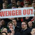 A fan holds up an anti-Arsene Wenger sign during the English Premier League football match between West Bromwich Albion and Arsenal March 18, 2017