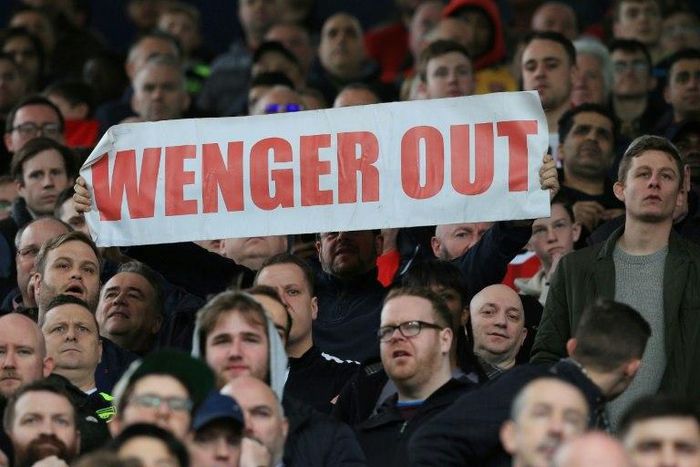 A fan holds up an anti-Arsene Wenger sign during the English Premier League football match between West Bromwich Albion and Arsenal March 18, 2017