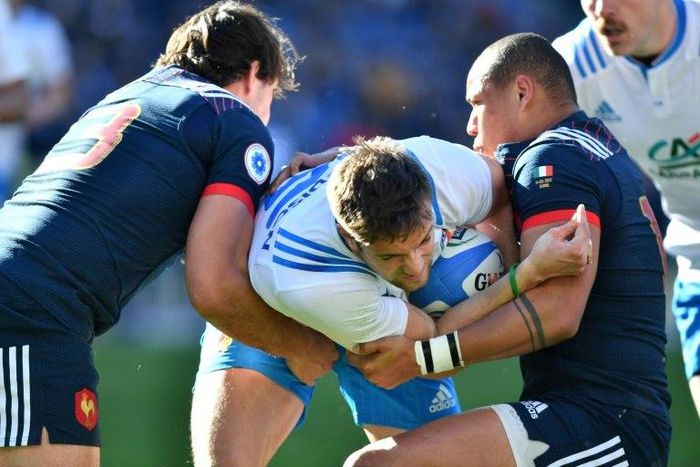 Italy's fly-half Edoardo Padovani (C) fights for the ball with France's center Gael Fickou (R) during their Six Nations rugby union match, at the Olympic Stadium in Rome, on March 11, 2017
