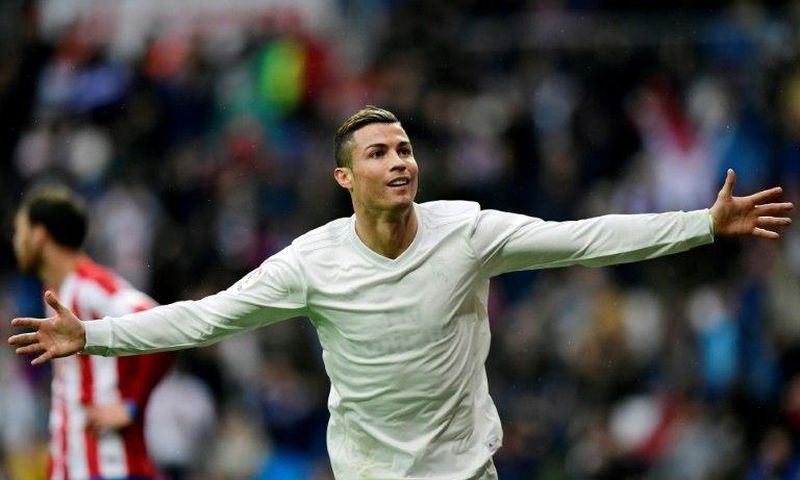 Real Madrid's forward Cristiano Ronaldo celebrates his second goal during the Spanish league football match against Real Sporting de Gijon November 26, 2016