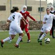 Players challenge for the ball in an exhibition game at Jordan's first women's football stadium in Amman on March 11, 2017